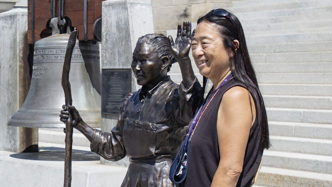 Idaho state Rep. Sue Chew, D-Boise, has her photo taken with a bronze statue of Idaho’s most famous Chinese pioneer and historical figure, Polly Bemis, during a ceremony for Polly Bemis Day at the Idaho State Capitol in Boise on Aug. 10, 2021. Bemis was sold as a slave from China and later lived a fascinating life along the Salmon River.