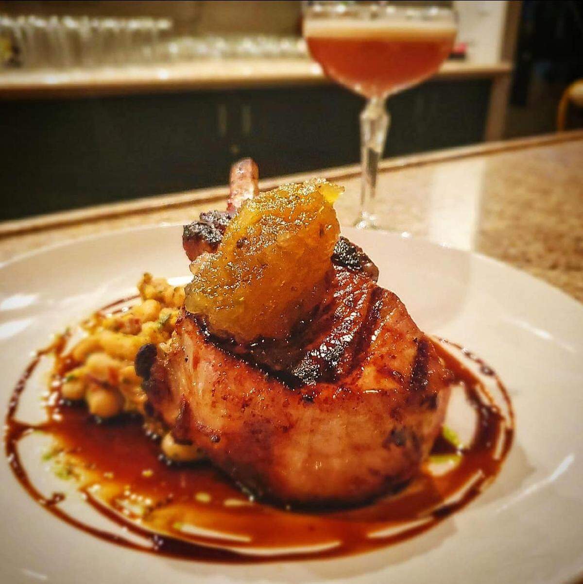 The maple-grilled Pork Chop ($24) comes with cannellini cassoulet, apple marmalade and Worcestershire gastrique.