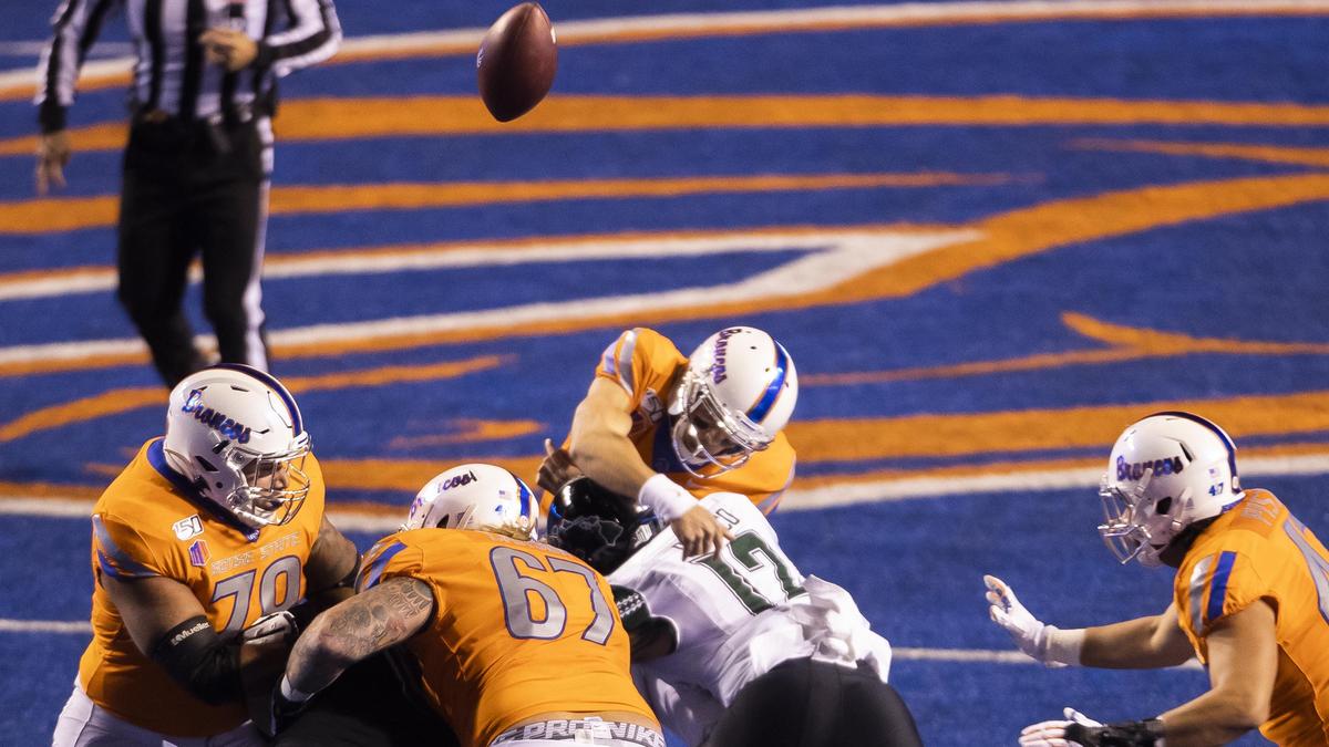 Boise State quarterback Hank Bachmeier gets hit as he releases a throw by Hawaii linebacker Kana’i Picanco (12) in the first quarter Saturday at Albertsons Stadium. Bachmeier was injured on a hit by Picanco later in the game.