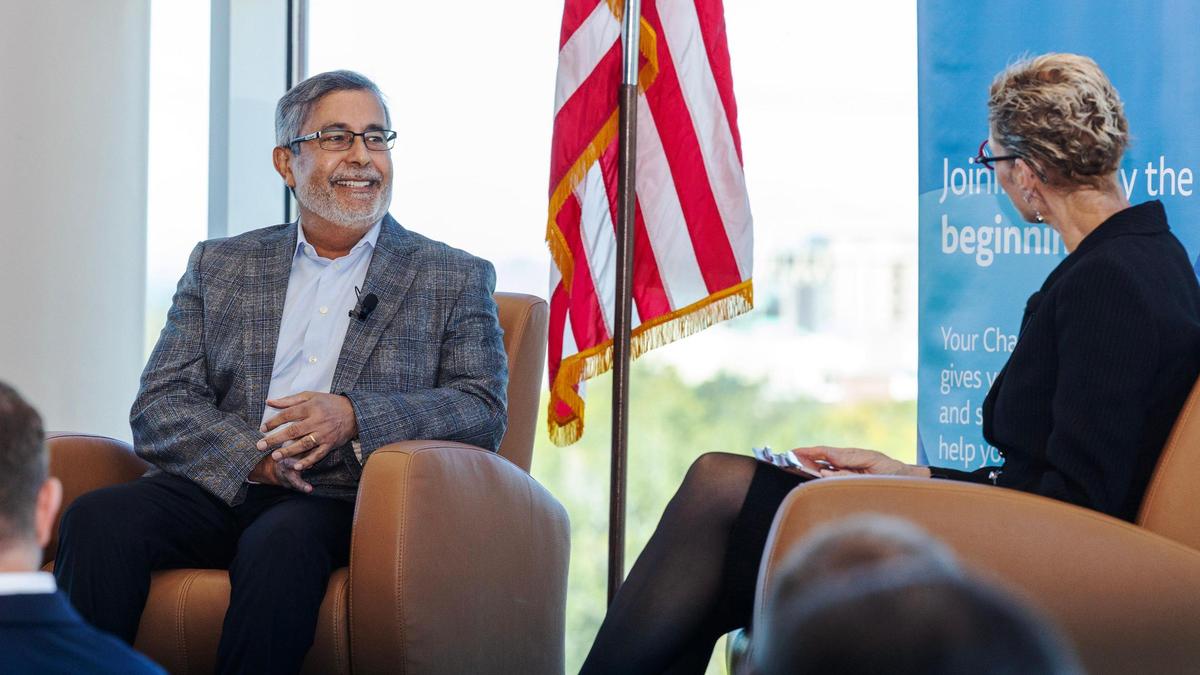 Micron CEO Sanjay Mehrotra, left, addresses a question from Boise State University President Marlene Tromp, right, during a Boise Metro Chamber of Commerce luncheon Wednesday at the Stueckle Sky Center.
