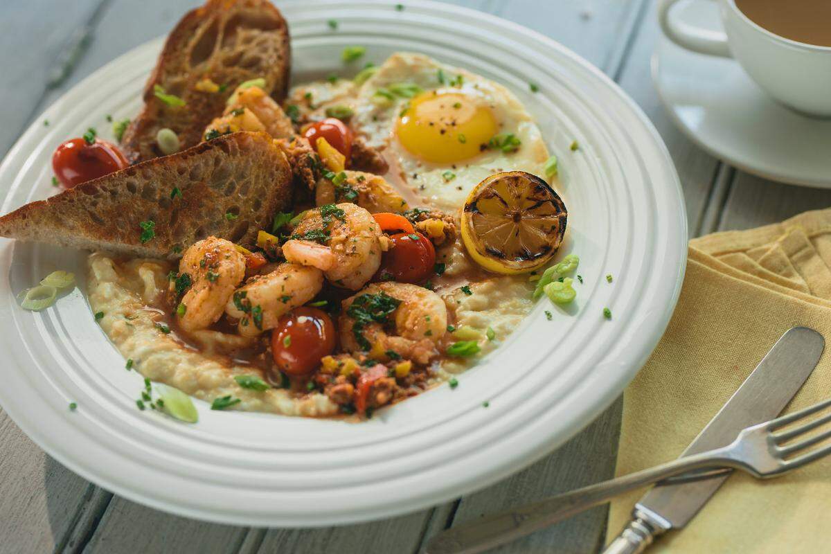 One of the chef-inspired entrees is Shoo Mercy Shrimp & Grits ($22.50) – “forever free” chorizo, sauteed spinach, blistered tomatoes and a fried egg.