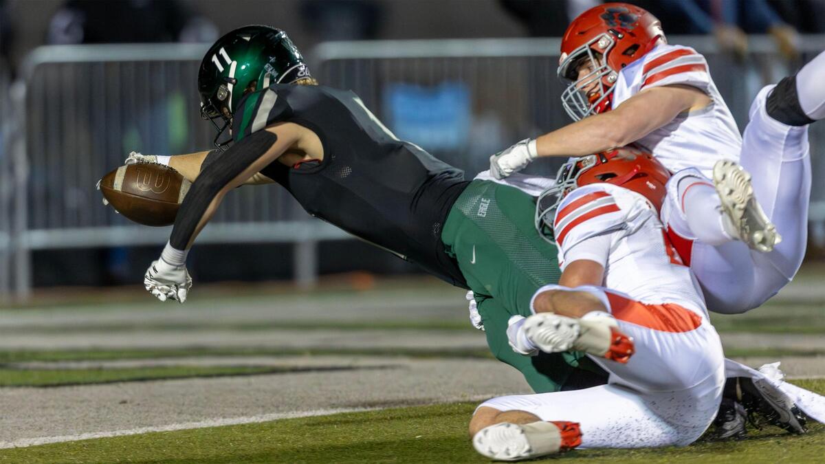 Eagle wide receiver Gavin Crawford lunges to get across the goal line for the Mustangs’ first score on an untimed down at the end of the first half.