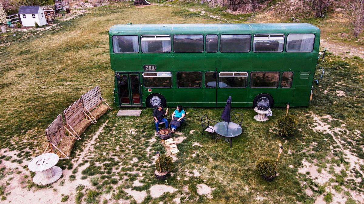 Parked in field near their Caldwell home where 30 pigs once roamed, this double-decker bus was converted by Angie and Dustin Mori into an Airbnb hideaway.