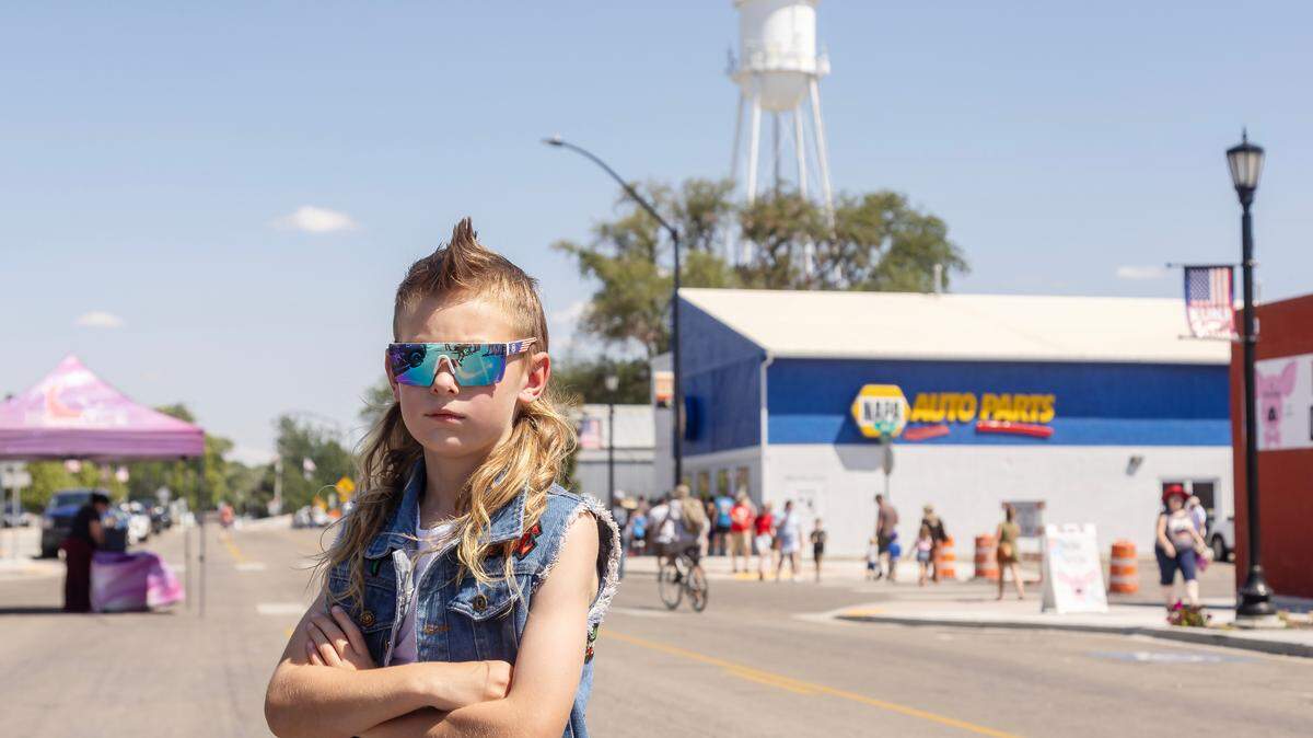 Easton Klinker poses with his mullet hairstyle at the Kuna Days festival held in downtown Kuna in 2023. Photographer Sarah Miller won first place for her news portrait photo of “Kuna Mullet Boy” in this year’s Idaho Press Club contest.