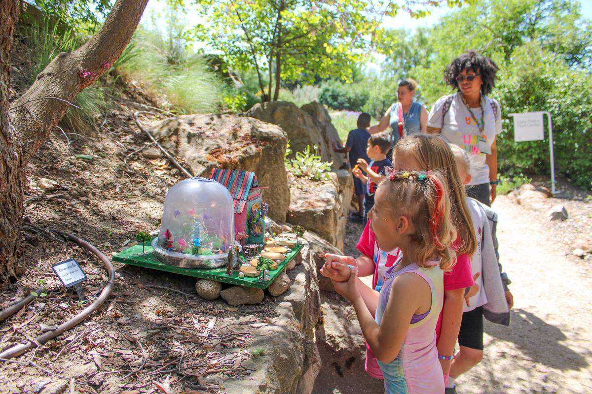 Children explore the Fairy and Gnome Homes Exhibit at the Idaho Botanical Garden.