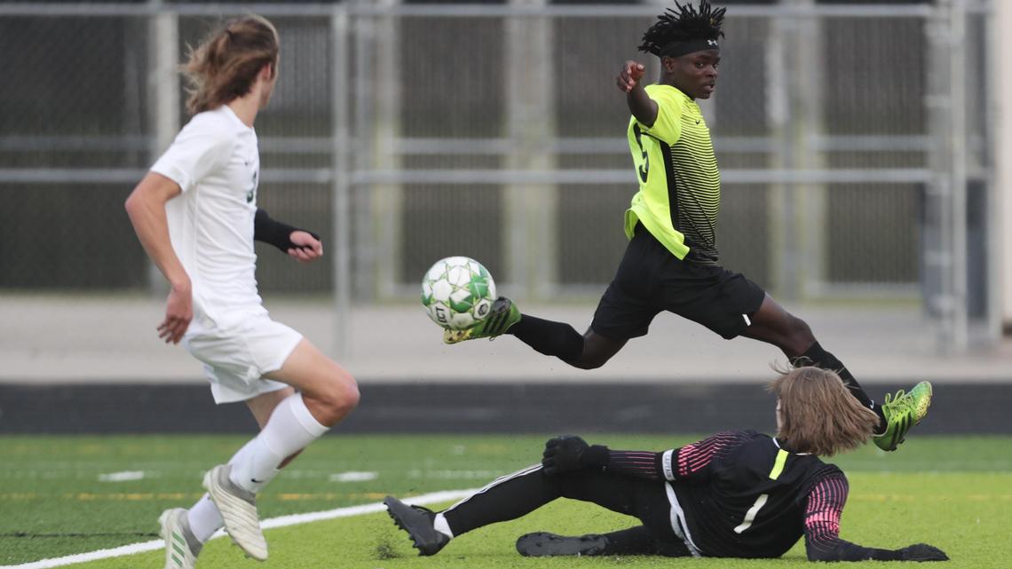 Borah’s Rama Ramadhani flies over the top of Eagle goalkeeper Drew Morris during the first half of the 5A District Three boys soccer championship match. Ramadhani scored the only goal in the second half, leading the Lions to the 1-0 win.