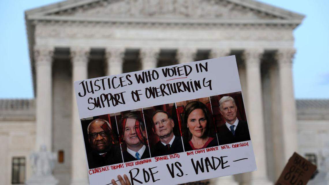 An activist holds up a sign during a rally in front of the U.S. Supreme Court in response to the leaked draft decision to overturn Roe v. Wade.