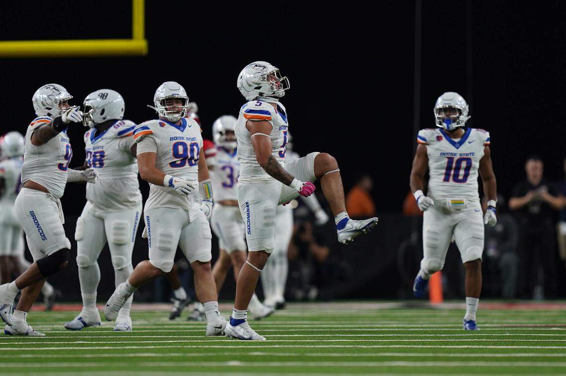 Boise State defensive end Jayden Virgin-Morgan (5) celebrates a sack with the rest of the defense Friday night, including linebacker Andrew Simpson (10), who had a critical interception just before halftime.