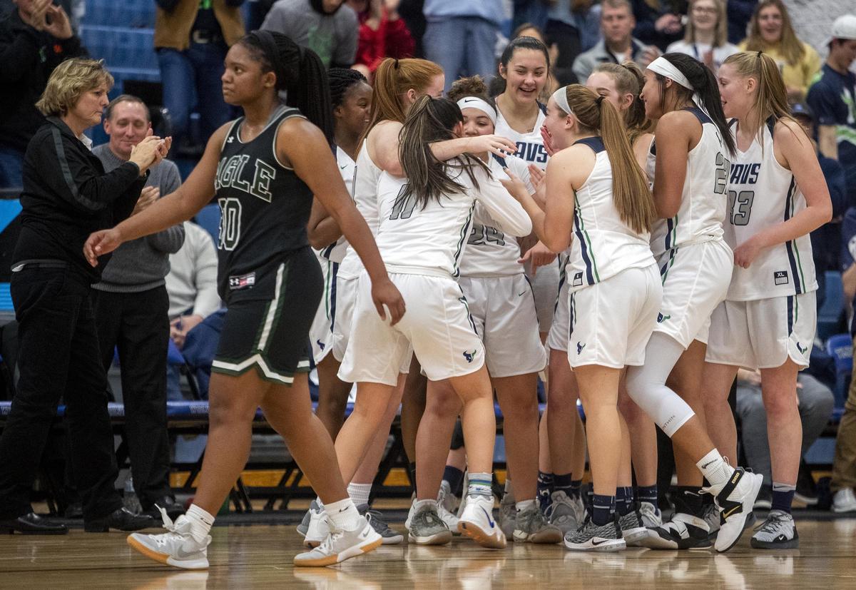 Mountain View celebrates winning the 5A SIC District Three championship 46-34 over Eagle Friday, Feb. 8, 2019 at Timberline High School in Boise.