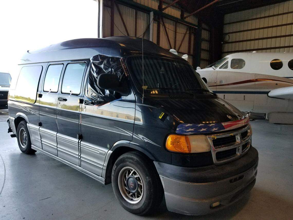 The black Dodge conversion van belonging to Steven Wolf, who was arrested on a murder charge in the death of a Florida woman on Nov. 21, 2018, sits inside the Monroe County Sheriff’s Office hangar in Marathon, Florida.