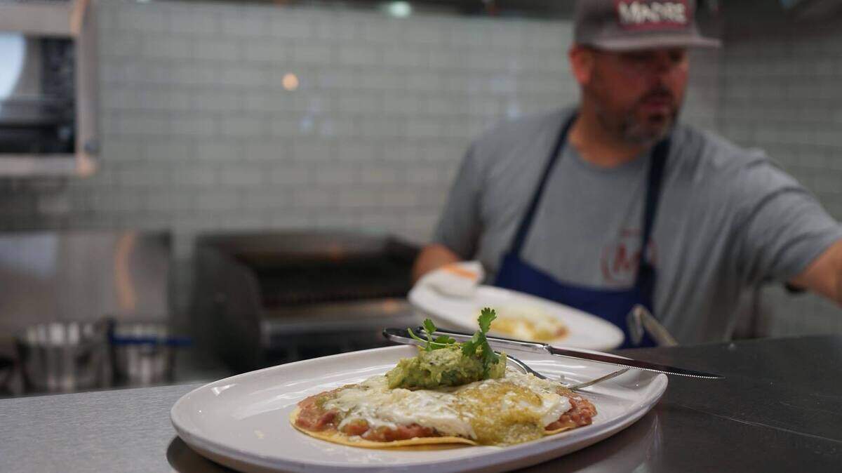 Chef and co-owner John Cuevas whips up huevos rancheros for contractors at his new taqueria, Madre, set to open this week in the Lusk District.