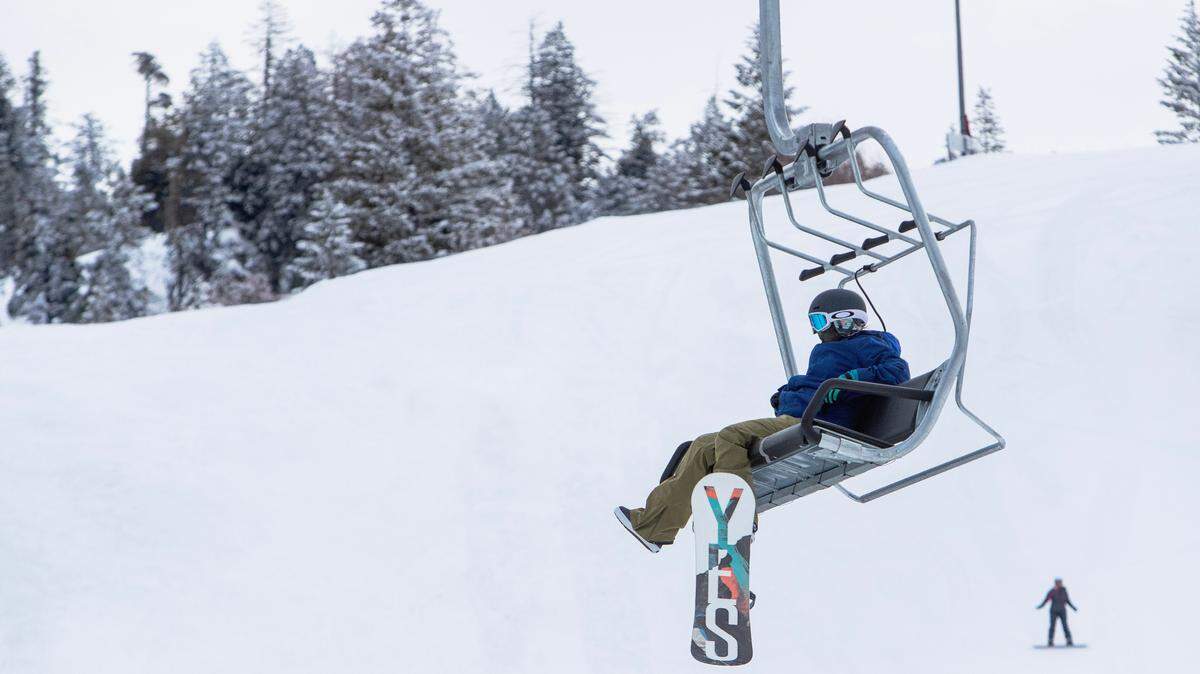 A snowboarder rides a chairlift at Bogus Basin on Jan. 23, 2023.