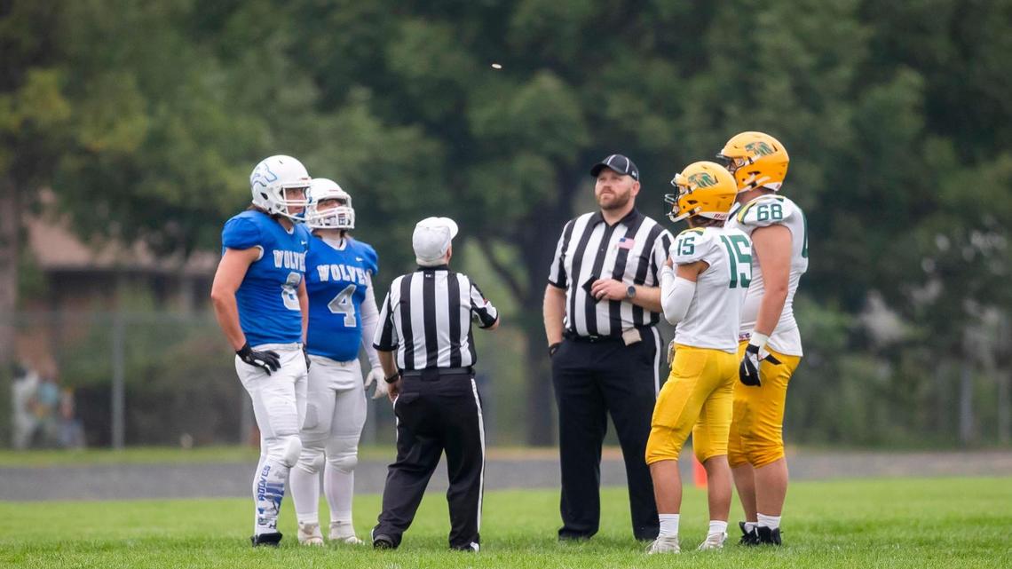 Referees flip a coin at the start of the Timberline vs. Borah football game last fall.