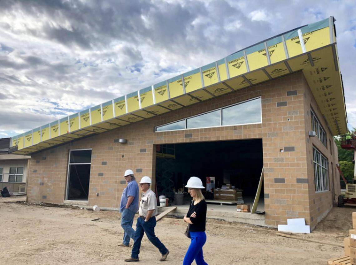 Ed Niehay, left, projects manager for BSD Capital Projects, Jay Allred, superintendent for Scott Hedrick Construciton, and Lindsay Egbert from Hummel Architects view the progress of the new kitchen and cafeteria at Koelsch Elementary School.