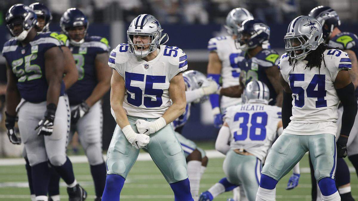 Dallas Cowboys linebackers Leighton Vander Esch, left, and Jaylon Smith, right, celebrate a defensive play against the Seattle Seahawks during the second half of their NFC wild-card game Jan. 5 in Arlington, Texas.