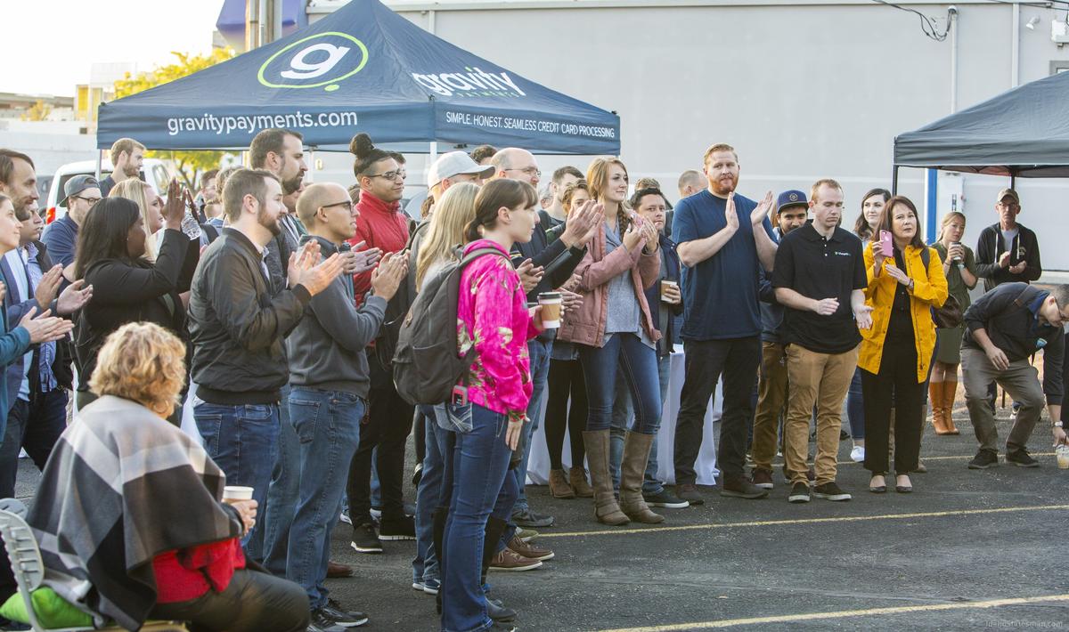 Employees applaud as Dan Price, CEO of Gravity Payments, announces that all Boise employees, who are currently earning a minimum of $40,000, will be given an immediate raise to $50,000 and will be phased to $70,000.