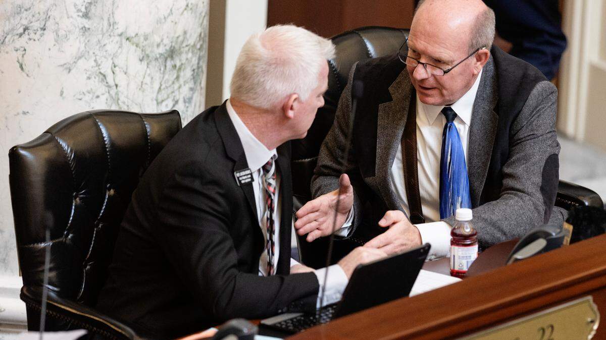 Idaho Rep. Jason Monks, R-Meridian, and House Speaker Mike Moyle, R-Star, talk during the legislative session in 2022. The Treasure Valley lawmakers helped craft a property tax relief proposal that would help schools reduce their debt on bonds and levies.