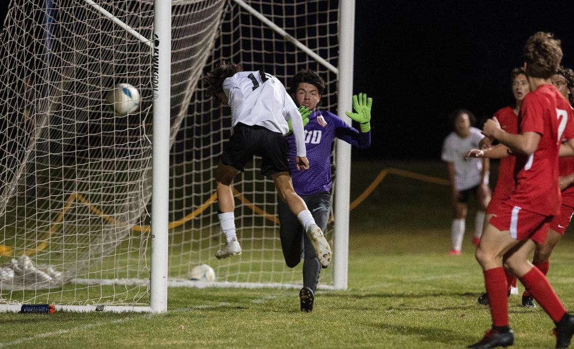 Bishop Kelly’s Landan Schweiger heads the opening goal past Sandpoint goalkeeper Roman Jiles in the 4A boys soccer state championship Saturday.