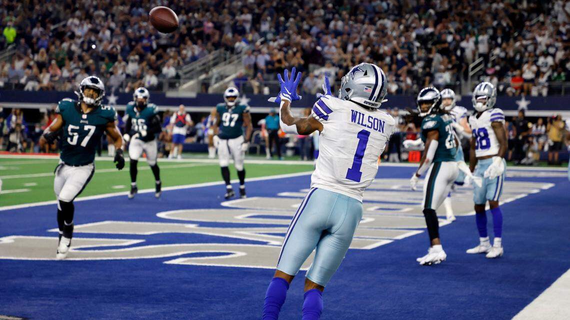 Dallas Cowboys wide receiver Cedrick Wilson reaches to catch a touchdown pass as Philadelphia Eagles linebacker T.J. Edwards and others look on in the second half of the Cowboys’ 41-21 win over the Eagles on Monday in Arlington, Texas.
