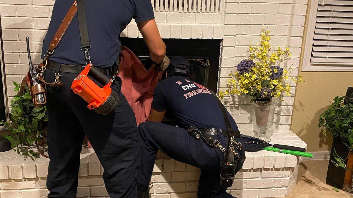 Boise Fire’s Engine 10 crew work at the fireplace where an owl was stuck.