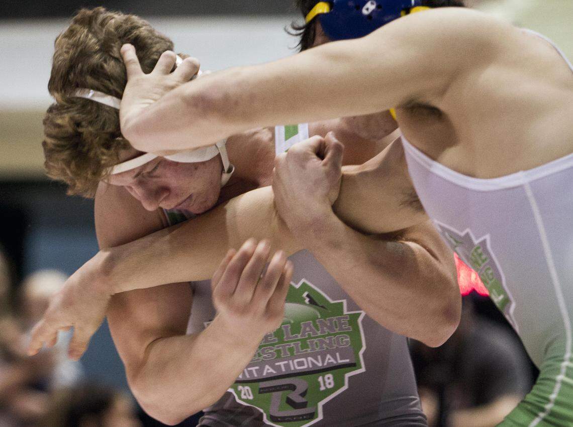 Fruitland senior Jonathon Fagen, left, seeks to become the 26th wrestler in state history to win four state titles this weekend.