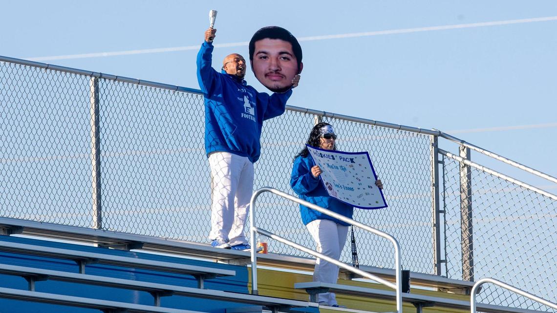 A pair of Emmett fans keep their distance and cheer for the Huskies during the 4A state football championship Nov. 21 at Middleton High School.