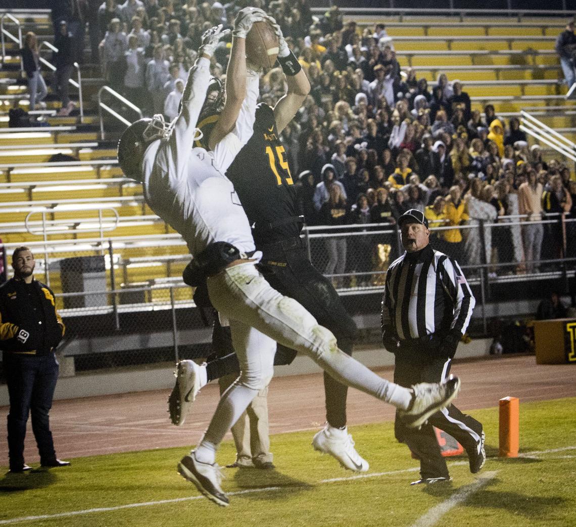 Bishop Kelly’s Matt Heffner hauls in a touchdown pass while battling with Vallivue’s Jayden Moran in the 4A state semifinals Friday.
