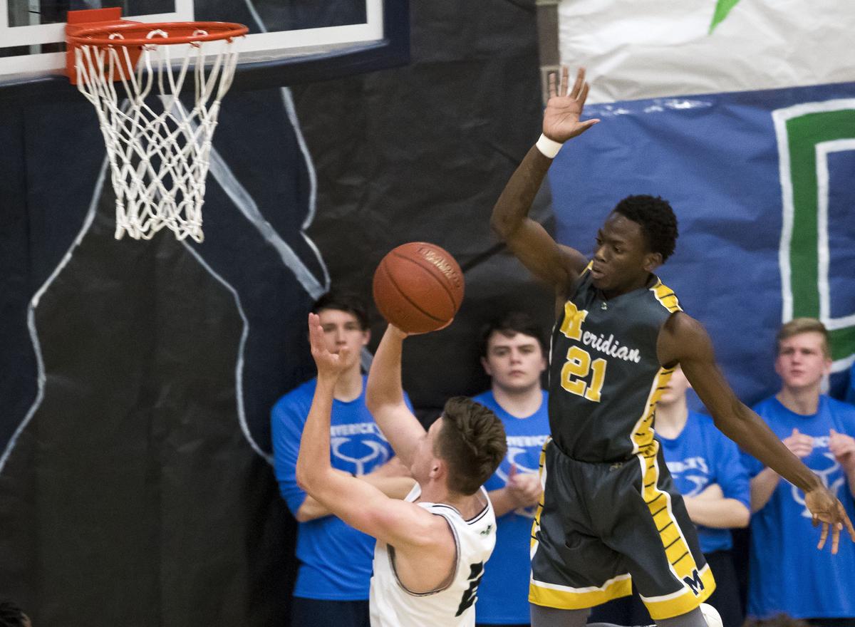 Meridian senior Josiah Seward rises above Mountain View’s Jazon Gentry to defend a fastbreak, but is called for a foul Tuesday, Jan. 22, 2019 at Mountain View High School in Meridian.