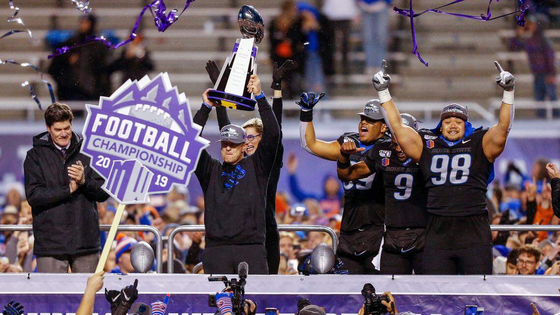 Former Boise State coach Bryan Harsin holds up the Mountain West Championship trophy in 2019 after it was presented to him by Mountain West Commissioner Craig Thompson. Thompson has been fighting for an expanded College Football Playoff for over a decade.