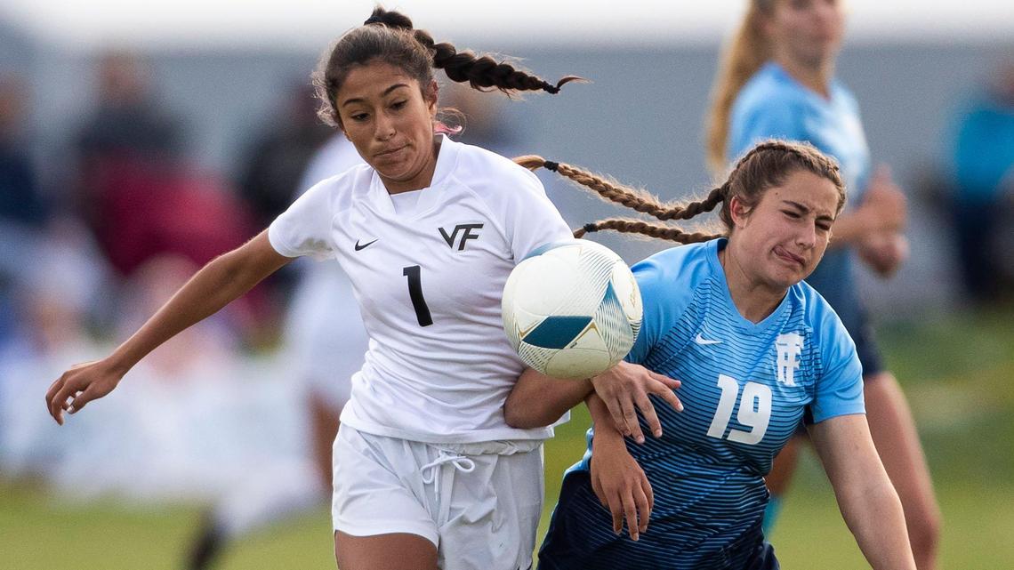 Vallivue forward Alondra Osuna battles with Twin Falls’ Miranda Wilson in the 4A girls soccer state championship Saturday at Middleton High.