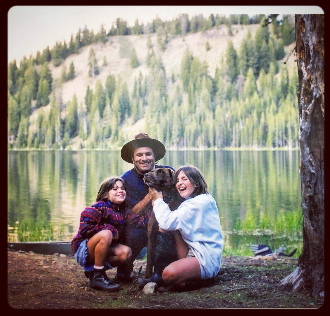 From left: Jamie Henke, Greg Henke and Jenn Henke hug their dog, Max, in a family photo at an Idaho lake.