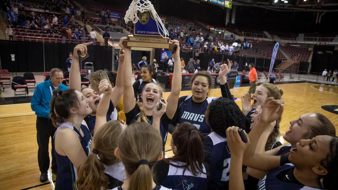 Mountain View hoists its second straight 5A girls basketball state championship trophy into the air after defeating Thunder Ridge 62-55 on Saturday at the Ford Idaho Center in Nampa.