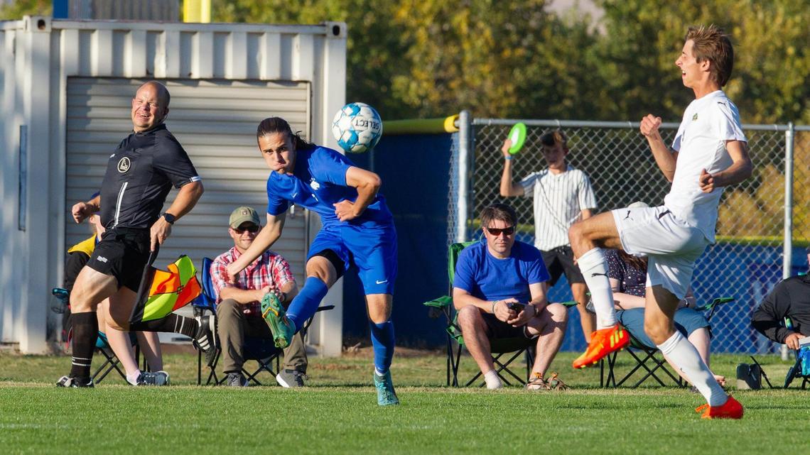 Timberline junior Quintin Boggs catches the ball off his back before Borah senior Michael Palsulich, right, can catch up during the Wolves’ 2-1 win in the 5A District Three championship Wednesday at Timberline High.