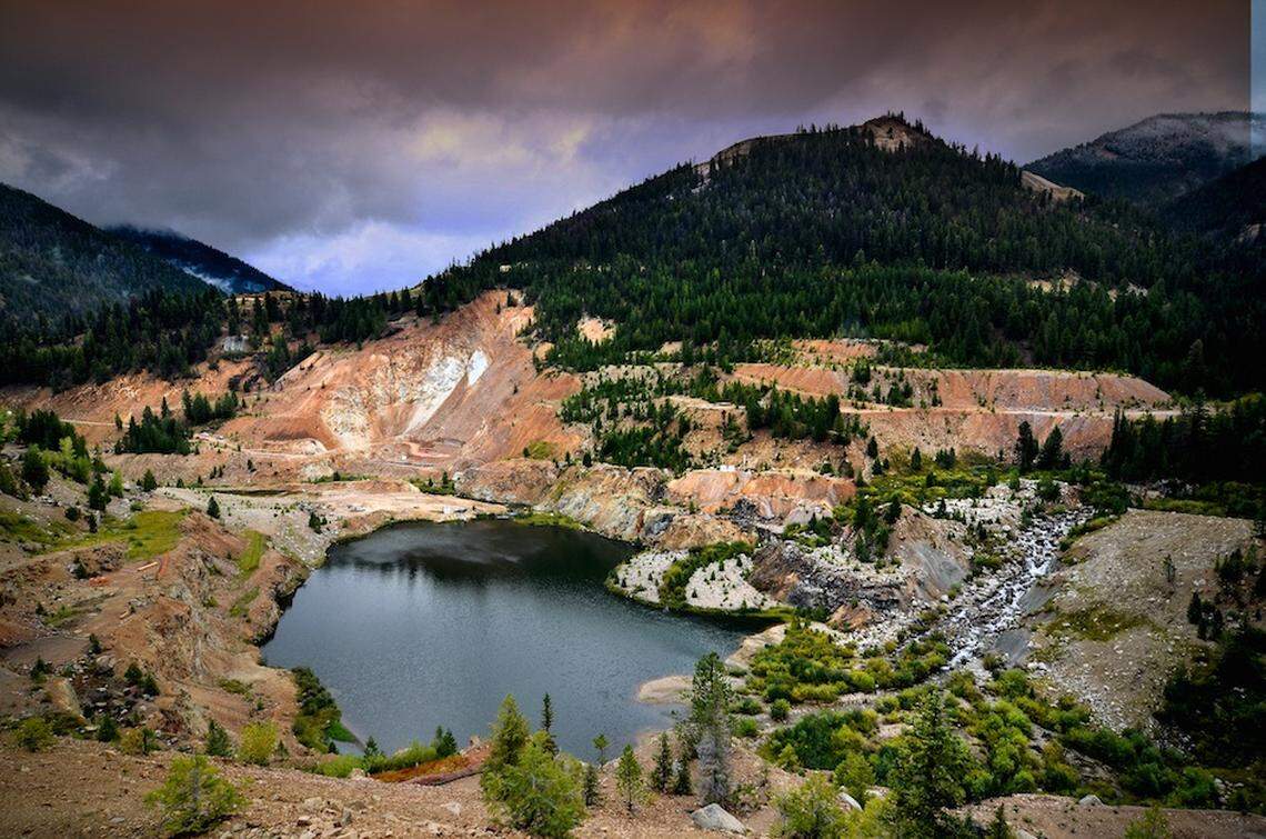 This is the abandoned Yellow Pine Pit at the Midas Gold site. The East Fork of the South Fork of the Salmon River flows into it. The high walls of the pit are a barrier to fish trying to reach native spawning grounds. Midas Gold says it will allow the pit to fill with sediment, then install a drain upstream on Blowout Creek to reduce sediment inflows, then rebuild the natural channels of the East Fork to allow fish migration to return.