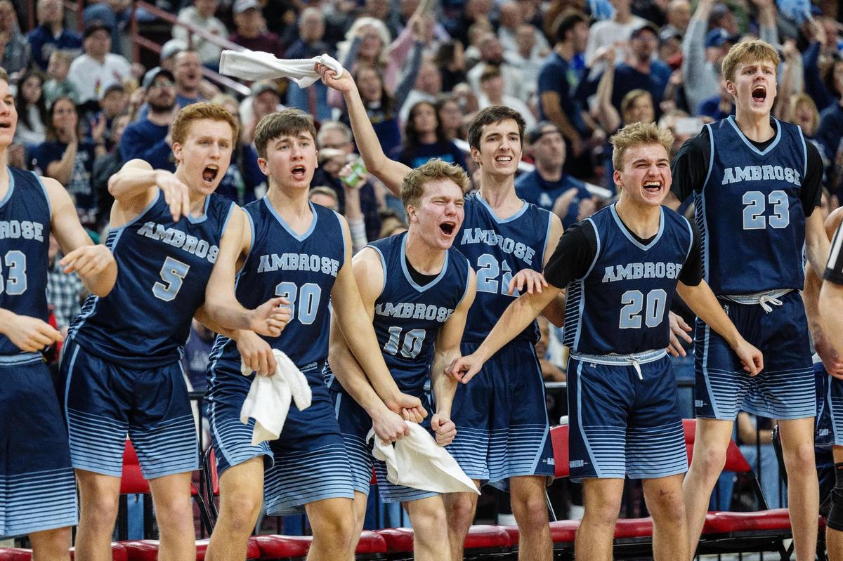 Ambrose players on the sideline react to a 3-point basket during the 2A state championship game last season at the Ford Idaho Center in Nampa.