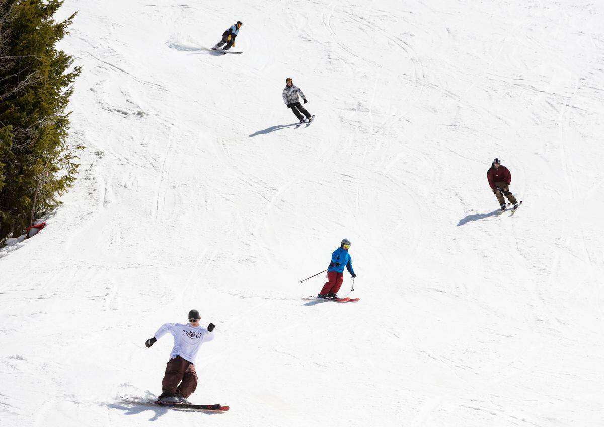People ski and snowboard on the last day of the season at Bogus Basin on April 3.