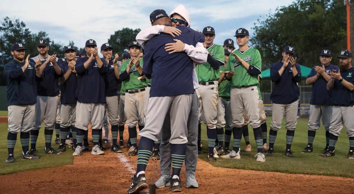 Mountain View baseball coach Matt Rasmussen gives Riley Harrison a hug as he awards gold medals to his players after the Mavericks won their first state 5A baseball championship with a 19-2 win over Capital Saturday, May 18, 2019 at Memorial Stadium in Boise. Pitcher Riley Harrison was hit in the head by a line drive in the district championship game and is still recovering from the injury.