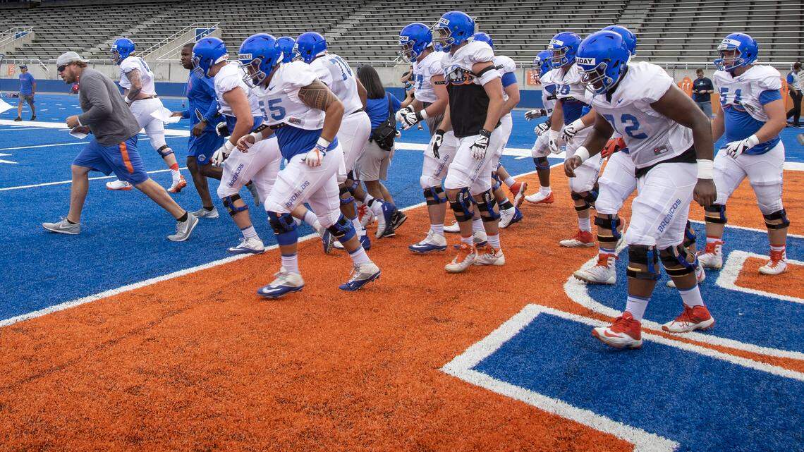 Boise State’s offensive line heads to its next drill during a fall camp practice.