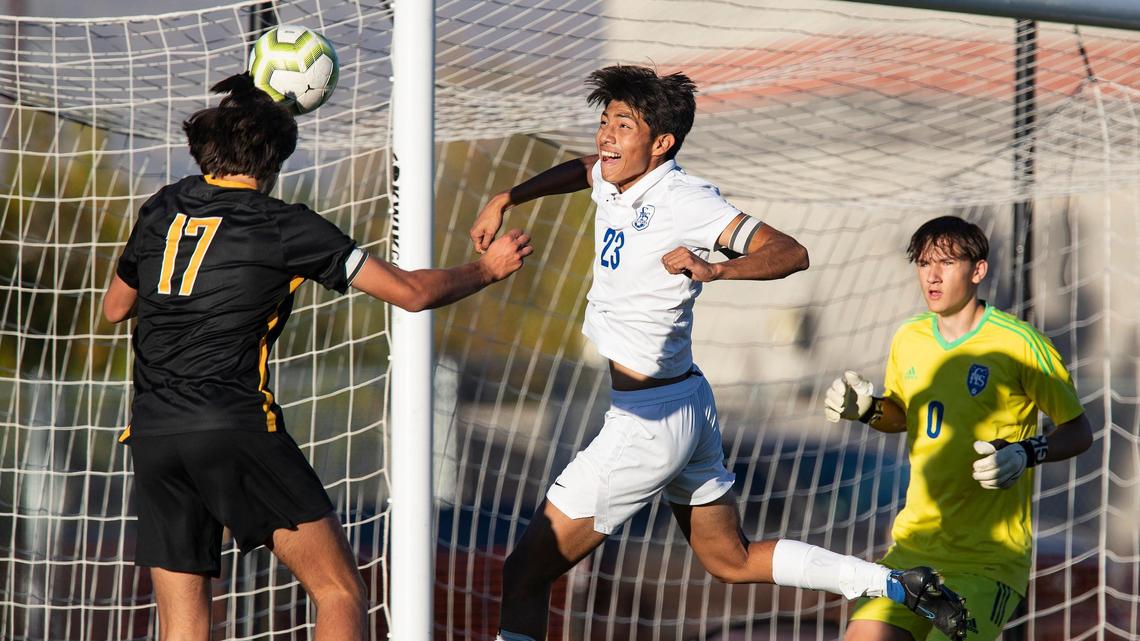 Bishop Kelly midfielder Sebastian Carranza’s header sails wide as Caldwell midfielder Chris Aguilera and goalie Greysen Porter scramble to cover Tuesday at Bishop Kelly.