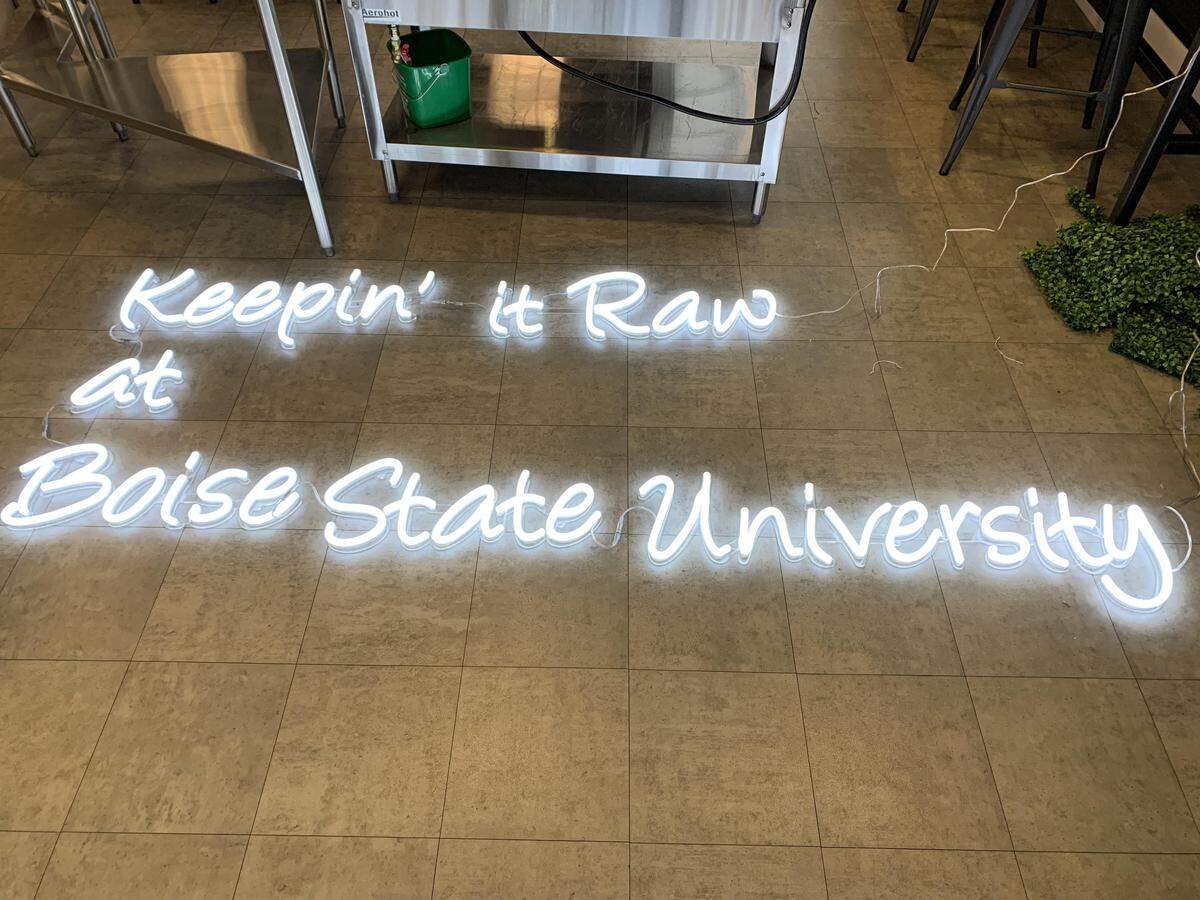 Each Paddles Up Poke restaurant features a customized “Keepin’ It Raw” sign. This one will go on the wall at BSU.