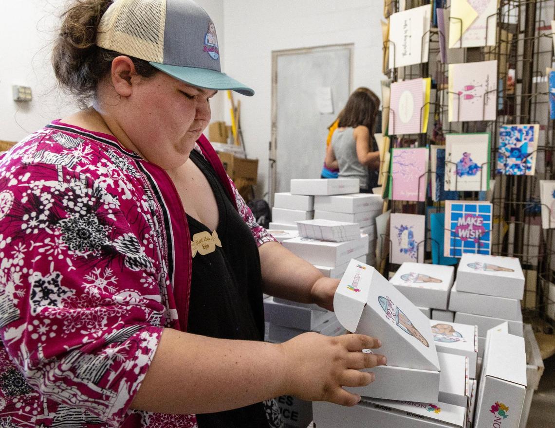 Sweet Zola’s Candy & Gift Shop employee Evie Heckthorn packs monthly subscription boxes at the store in Boise on Saturday.