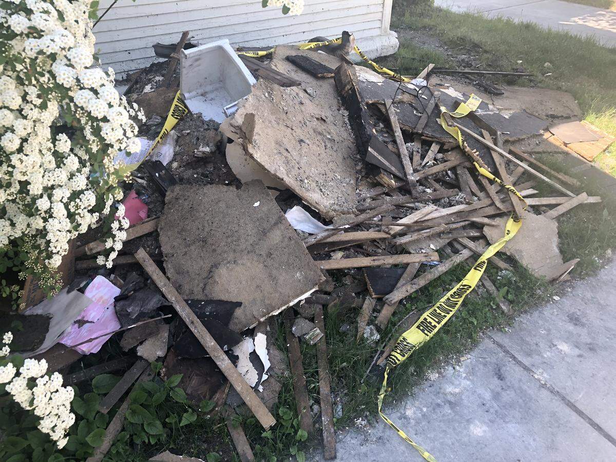 A pile of debris from an April 23, 2019, fire sits near the door of an apartment building at Jefferson and 14 streets in Downtown Boise.