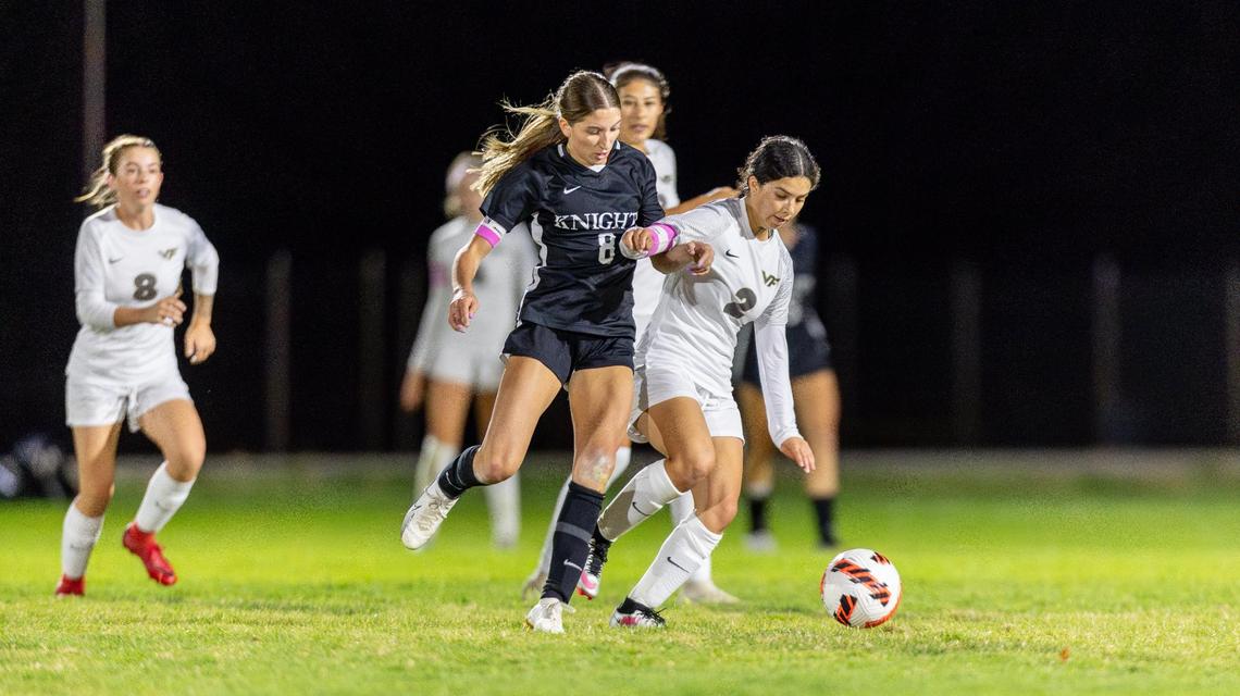 Bishop Kelly’s Sophie Schmautz, left, and Vallivue’s Jessica Ramirez battle for the ball in the second half of the 4A District Three Tournament championship Thursday.