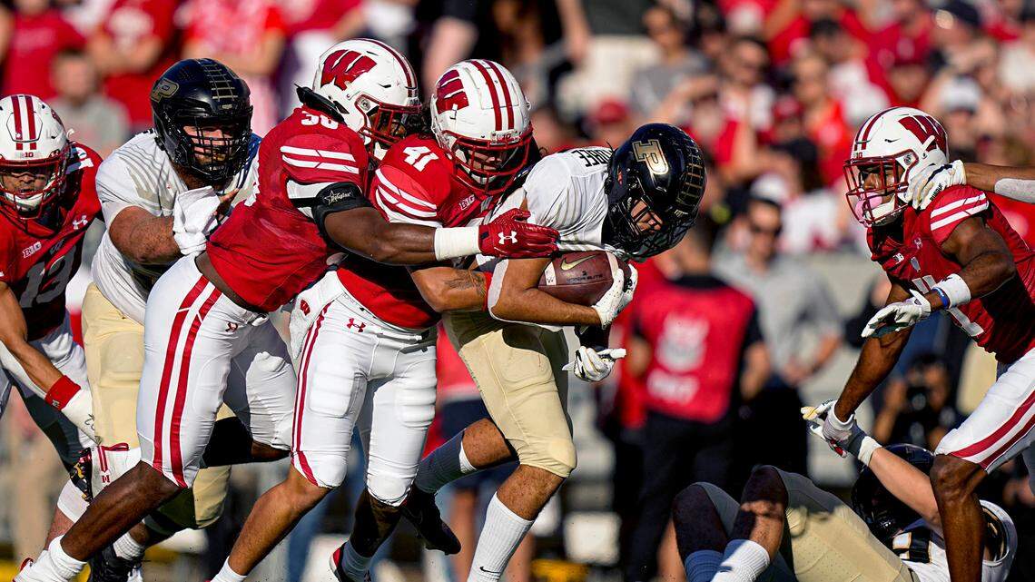 Wisconsin cornerback Lee Hutton (38) and safety Titus Toler (41) tackle Purdue running back Devin Mockobee (45) in October. Toler committed to Boise State on Monday. He has three years of eligibility remaining.