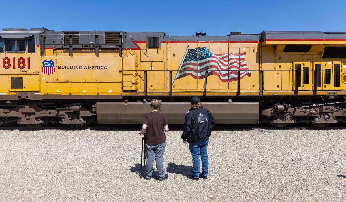 People stop to look at a train engine outside of the Boise Depot.