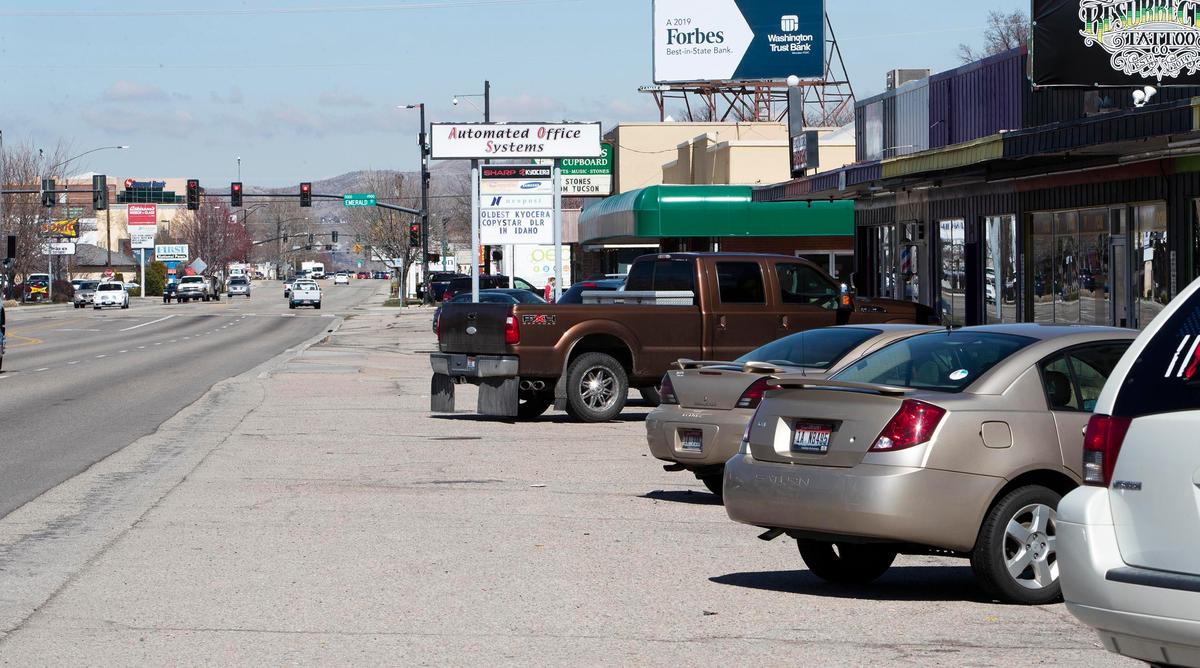 Parking lots front most businesses along Orchard Street, sometimes interrupting the sidewalk and creating obstacles for pedestrians.