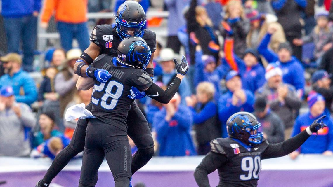 Boise State defenders Tyreque Jones (21), Kekaula Kaniho (28) and Scale Igiehon (90) celebrate a goal-line stop on fourth down during the 2019 Mountain West championship game against Hawaii at Albertsons Stadium.