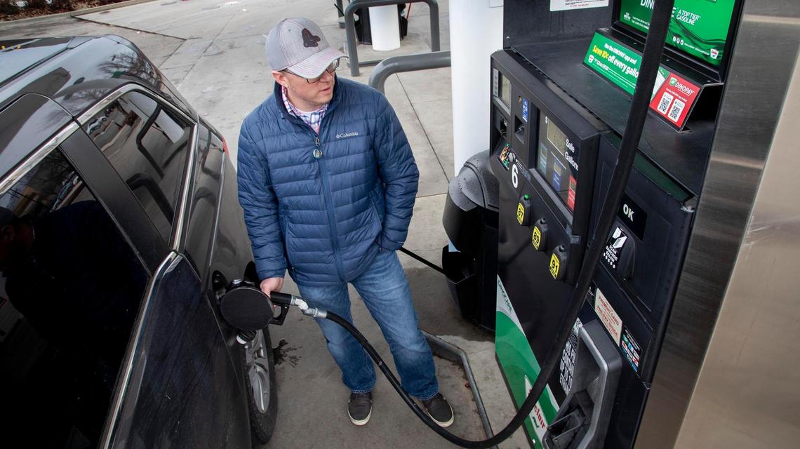 Christopher Ogden, traveling with his family from Eastern Idaho to Oregon, fills up the fuel tank of his vehicle at a Stinker Stores gas station in East Boise Wednesday, Feb. 3, 2021.