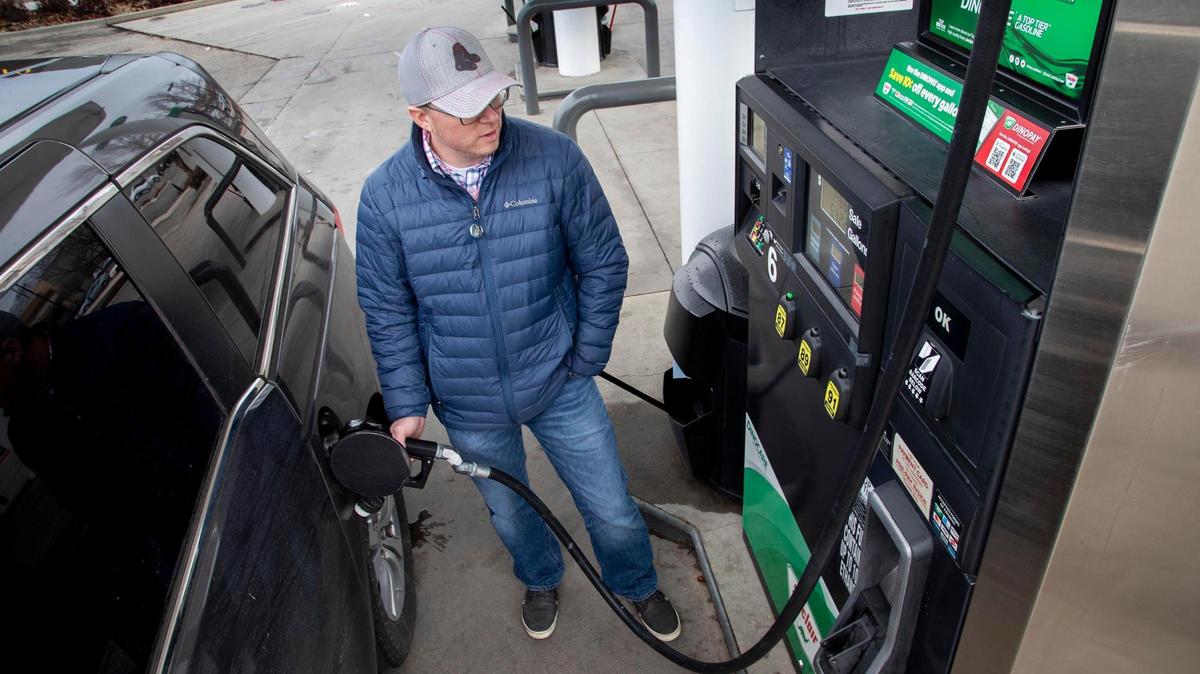 Christopher Ogden, traveling with his family from Eastern Idaho to Oregon, fills up the fuel tank of his vehicle at a Stinker Stores gas station in East Boise earlier this year.