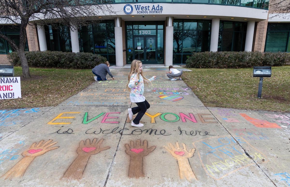 People gathered on a Sunday at the West Ada School District office in Meridian to chalk the words “Everyone is welcome here” after the district ordered a teacher to remove a classroom sign with the same message. The following day, the district instructed employees to wash the chalk away. 